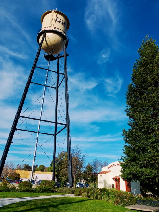 a tall metal tower on top of a green field