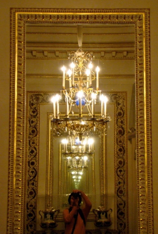 a mirror reflecting a man taking a picture of himself