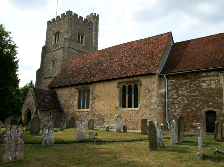 an old building with graveyard in front of it