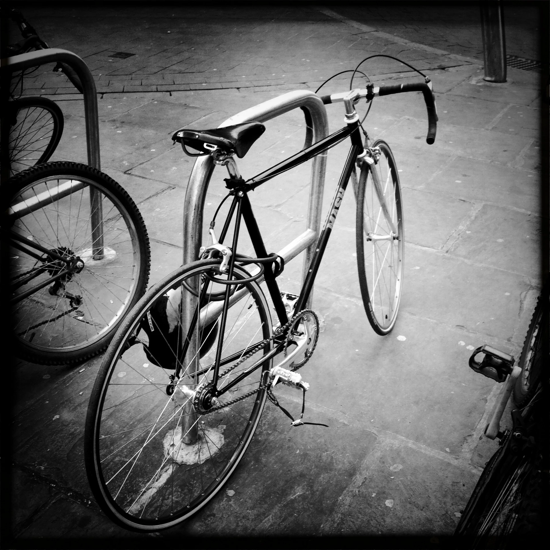 a bicycle parked next to another bike on a sidewalk