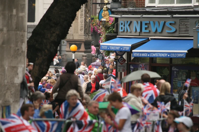 people walk down the street with flags and balloons