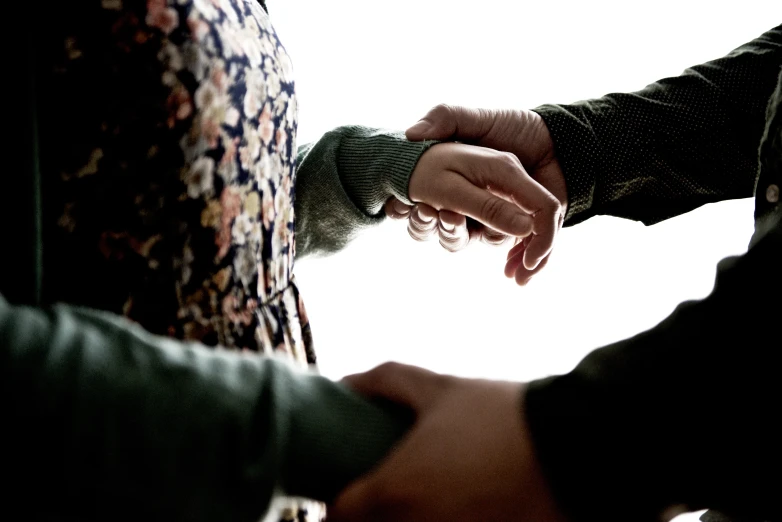 two people shaking hands on a chair