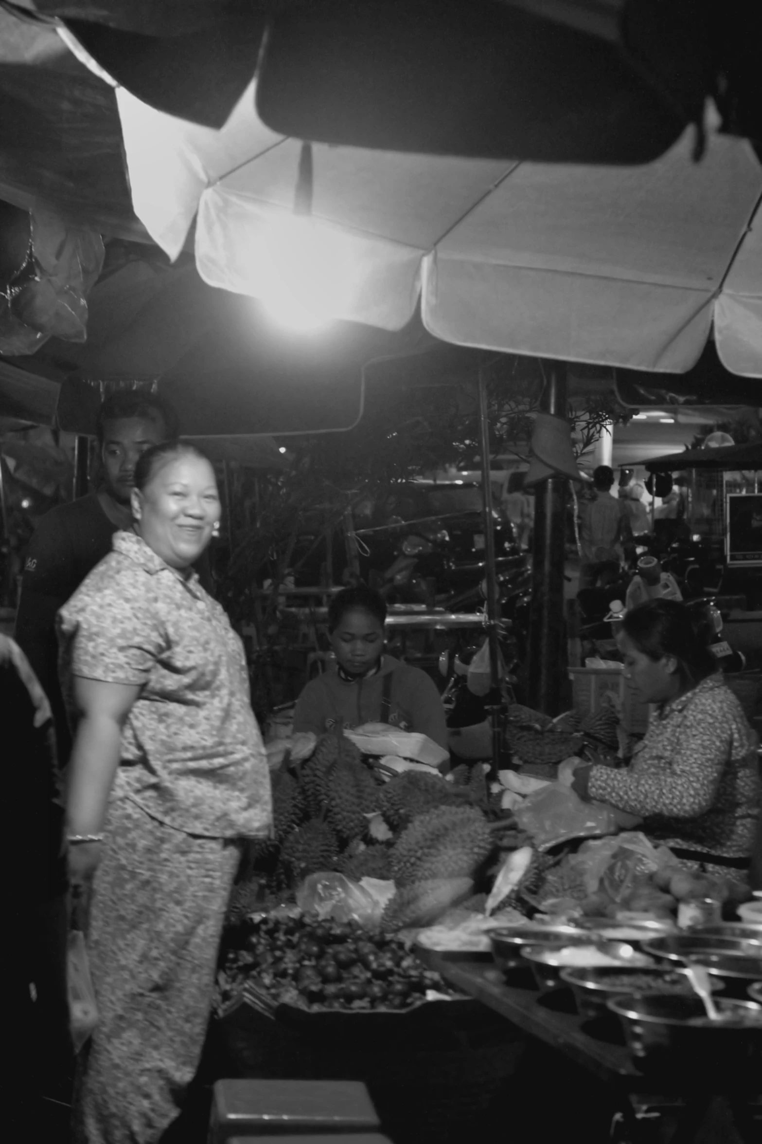 woman in the market selling food to people