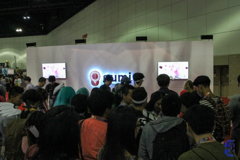 a group of young people in front of a screen