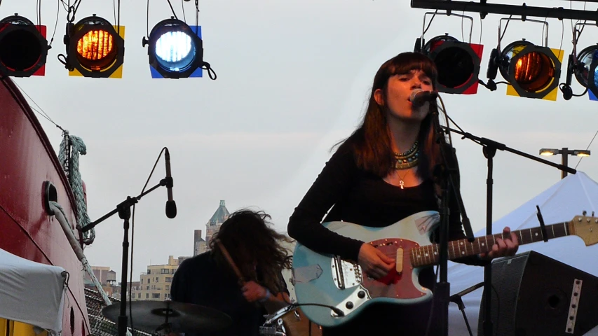 a group of musicians performing in front of spotlights