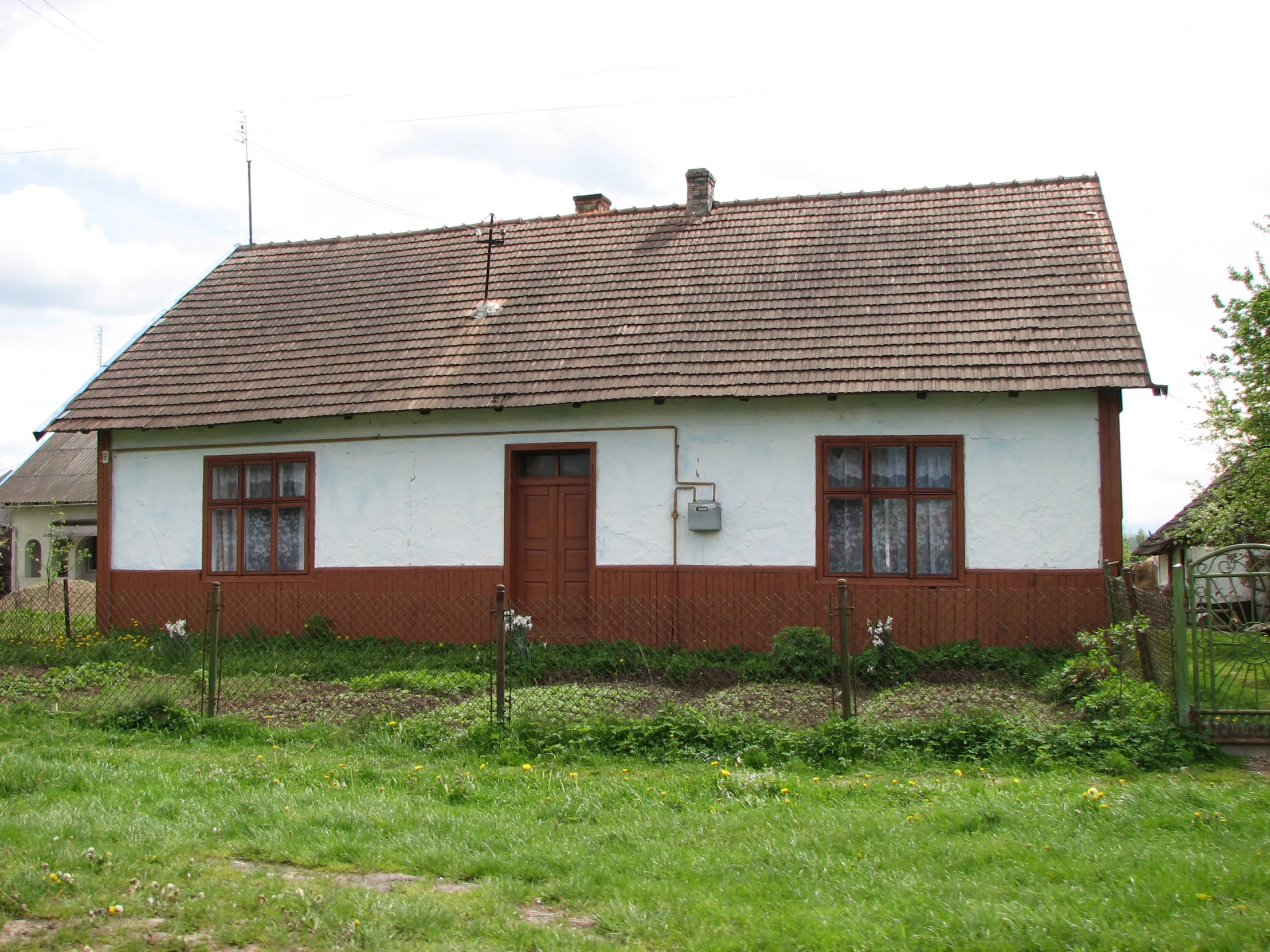 this is an old run down home with two chimneys