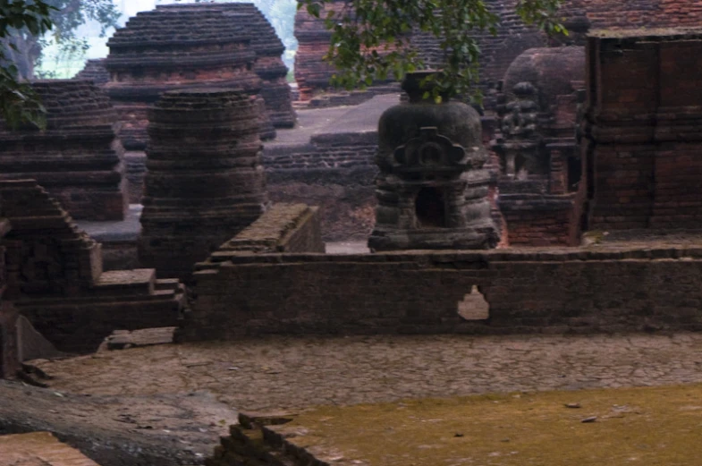 stone statues and carved structures in an old temple