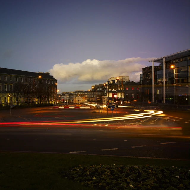 a city intersection with various building and cars traveling down the street