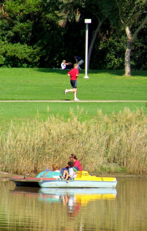 a boat in the water on a lake near people