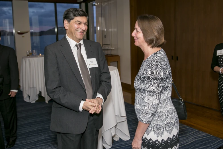 two people in suits having a conversation