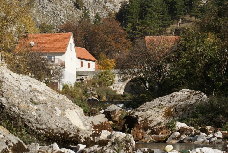 a house by the mountain near water