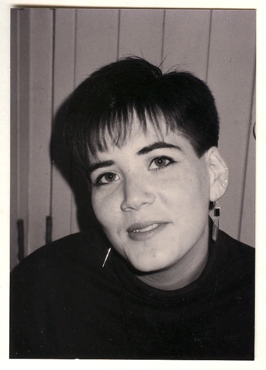 a black and white po of a person wearing ear nails