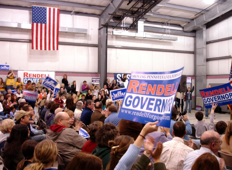 people are gathered together holding signs and posters