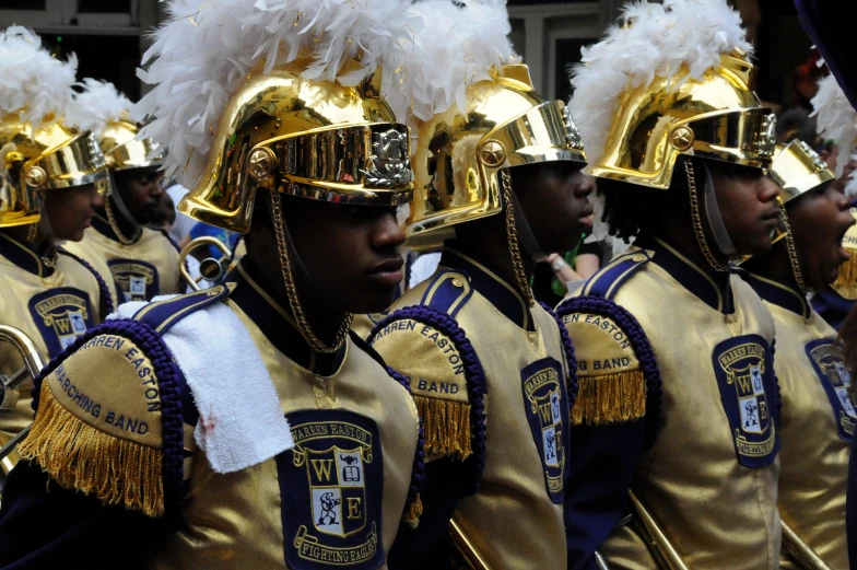 a large group of people wearing costumes while marching