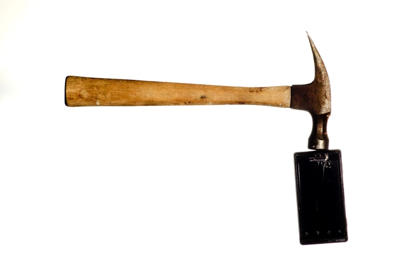 the wooden handle is attached to an old axe