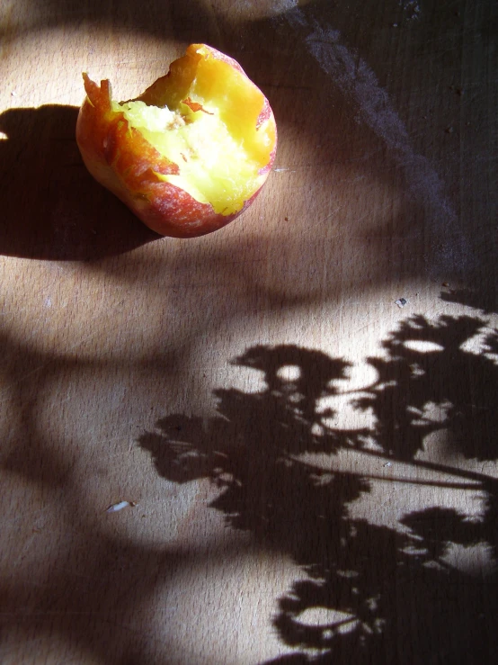 an apple is sitting on the wooden table