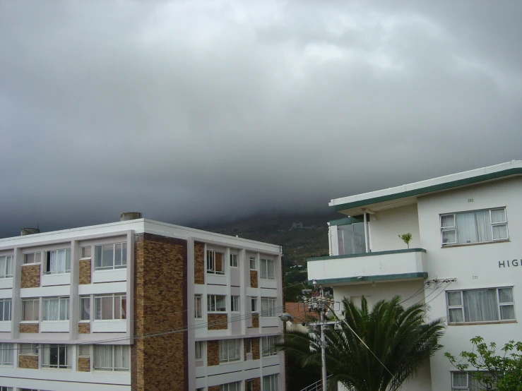 an image of some building that is under a stormy sky