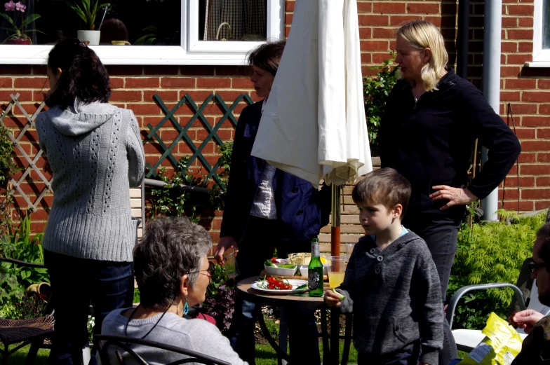 a group of people are outside talking to each other