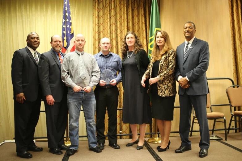 group of people standing together in front of a podium