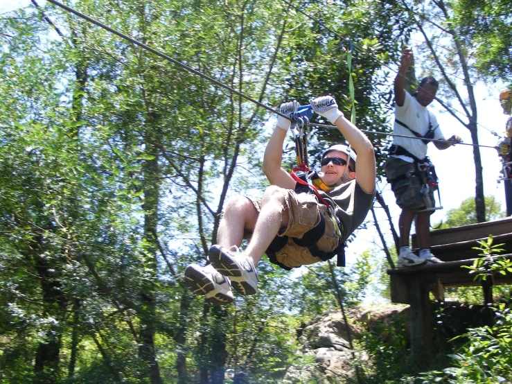 people standing on a small bridge flying through the air