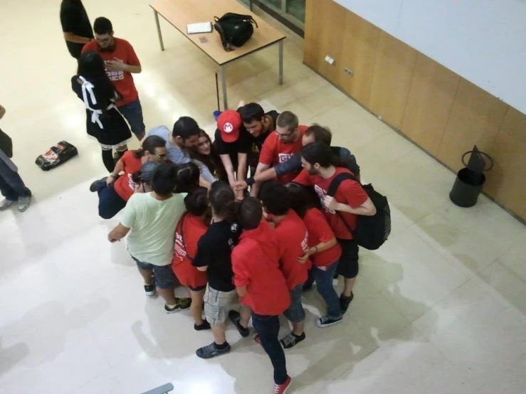 group of people surrounding each other with backpacks on