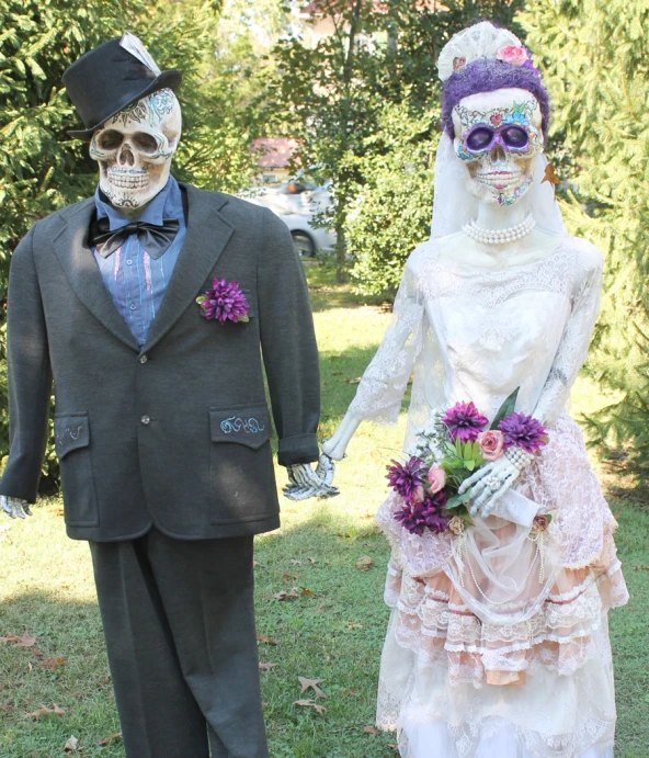 a skeleton dressed up in wedding dress and suit