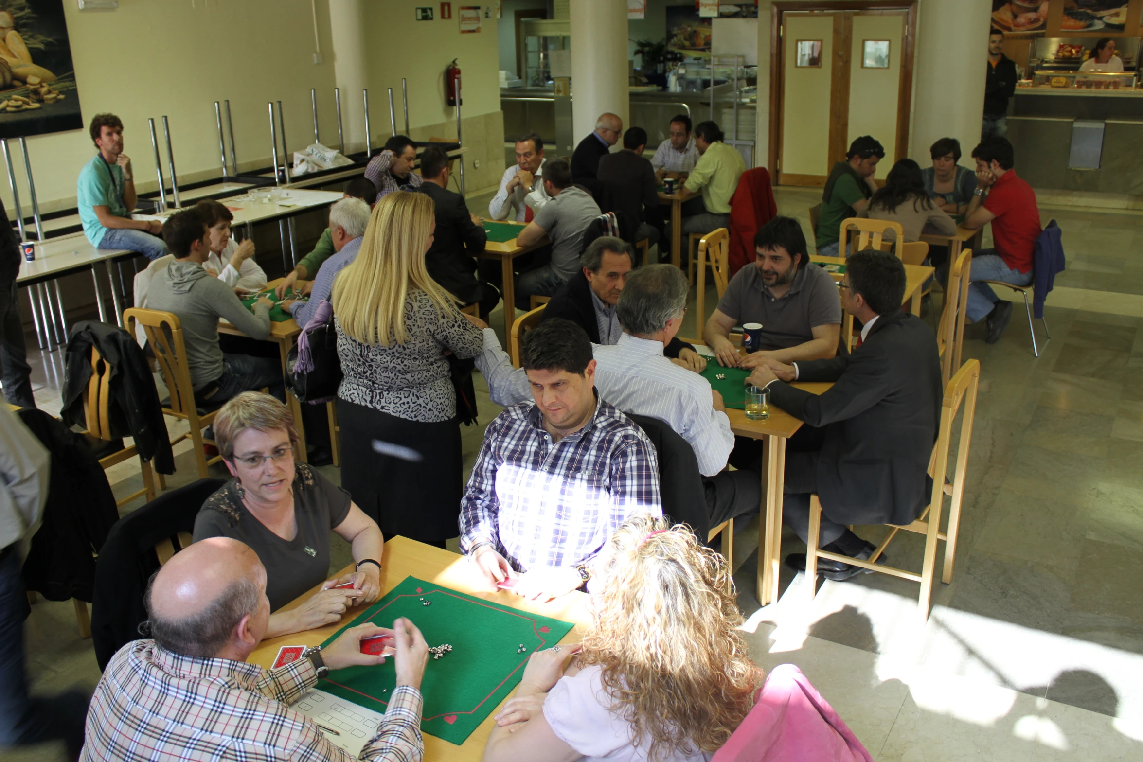 a number of people sitting at tables with food in front of them