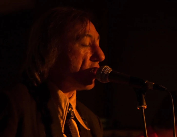 man singing into a microphone at a party