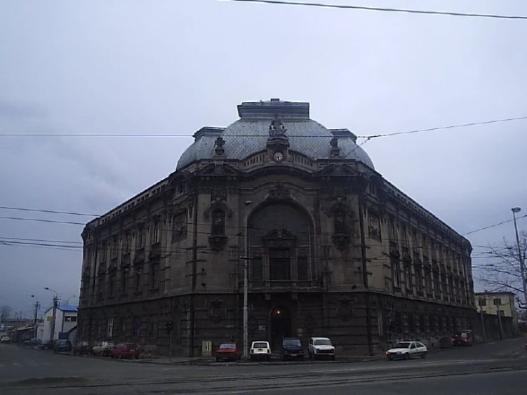 a large building on a corner in front of power lines