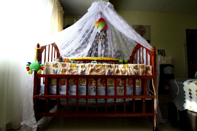 a baby's crib with a net on top of it