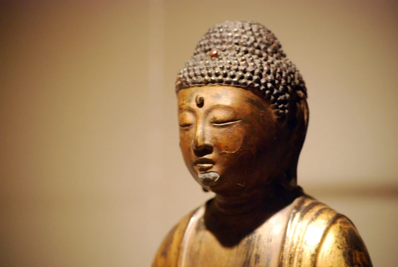 a statue of buddha with closed eyes