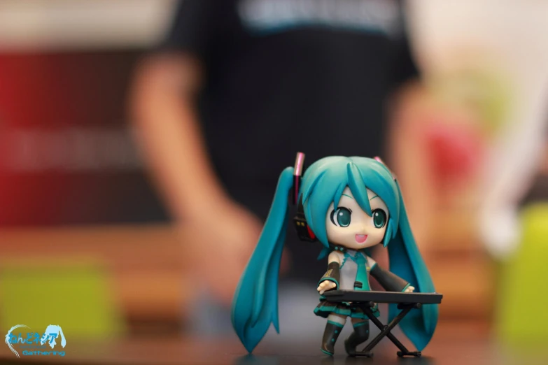 an anime doll sits in front of a desk