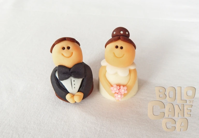 two grooms are shown on a cake