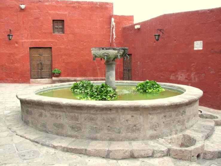 a fountain and some steps in front of a building