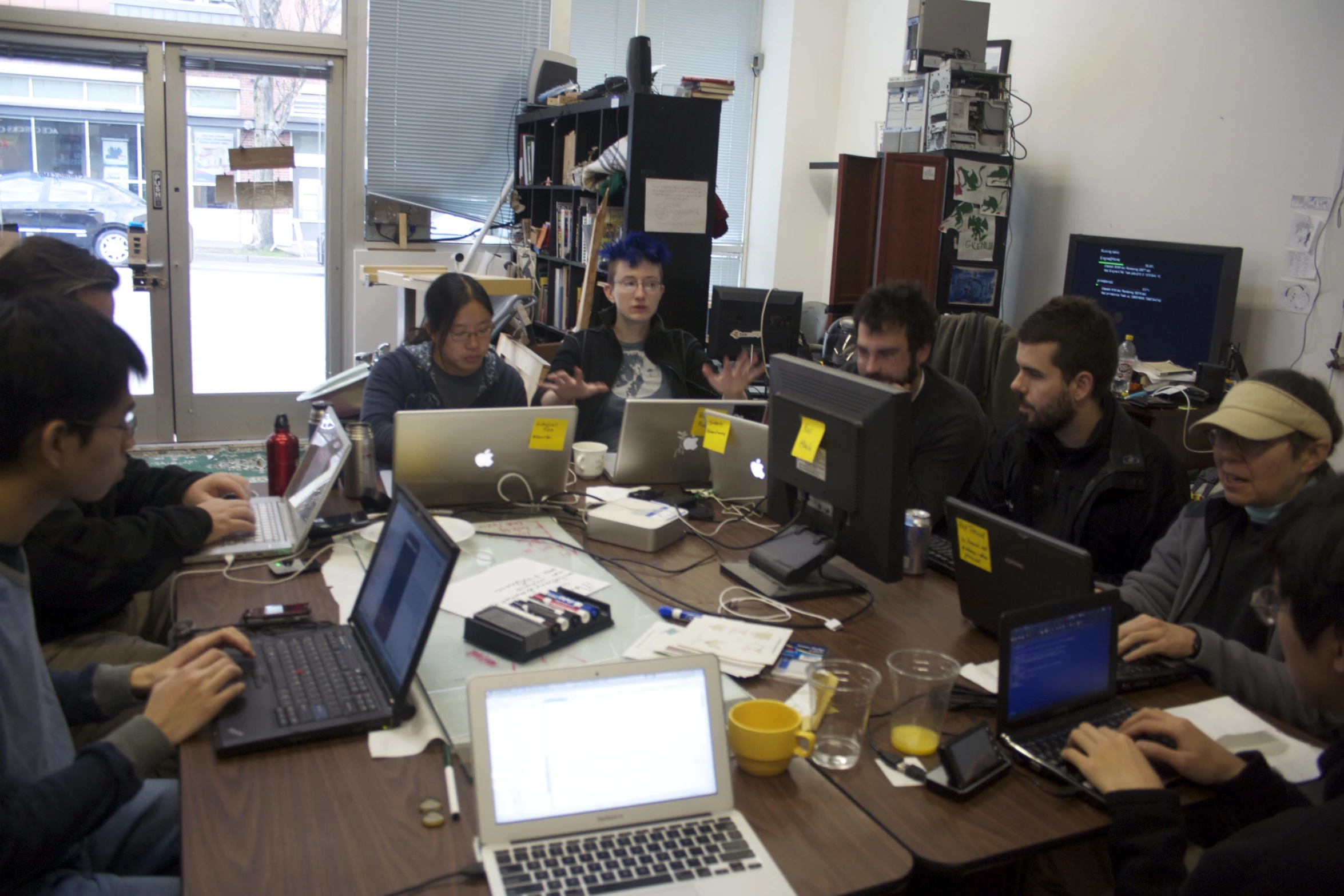 men in a workshop with laptops on a table