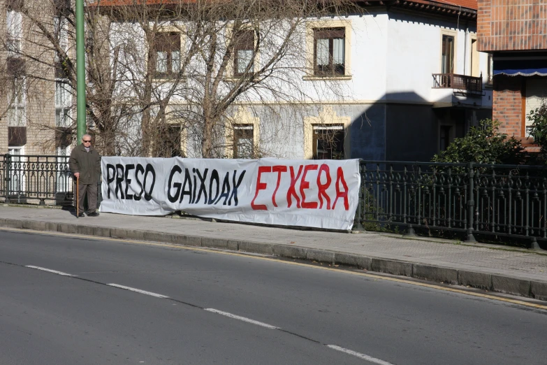 a protest banner with graffiti written on the side of it