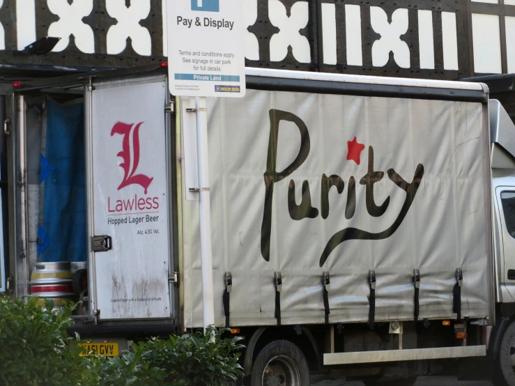 the back of a delivery truck parked at a curb