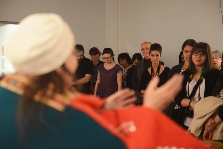 a group of people are shown as one person gives a speech to another