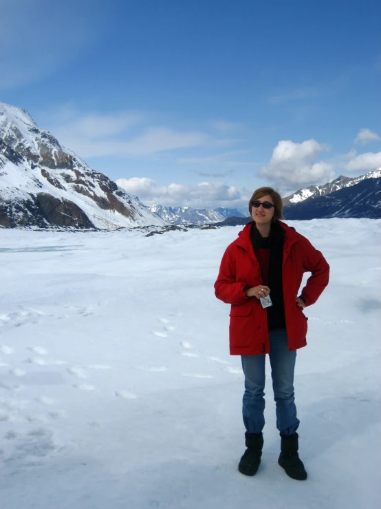 the woman standing in the snow is dressed in black