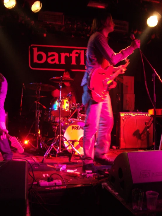 a band performing on a stage at a bar