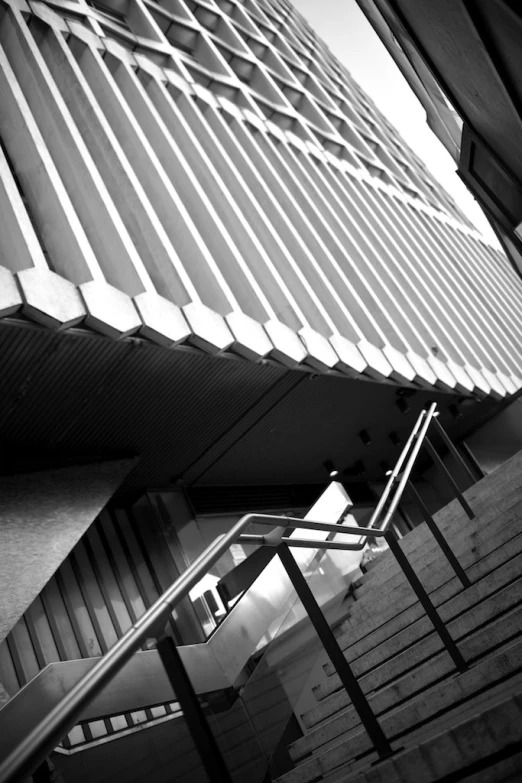 a stair case in front of a building with a metal handrail