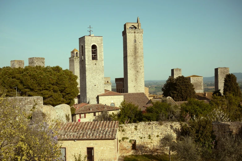 the old stone buildings sit in front of trees