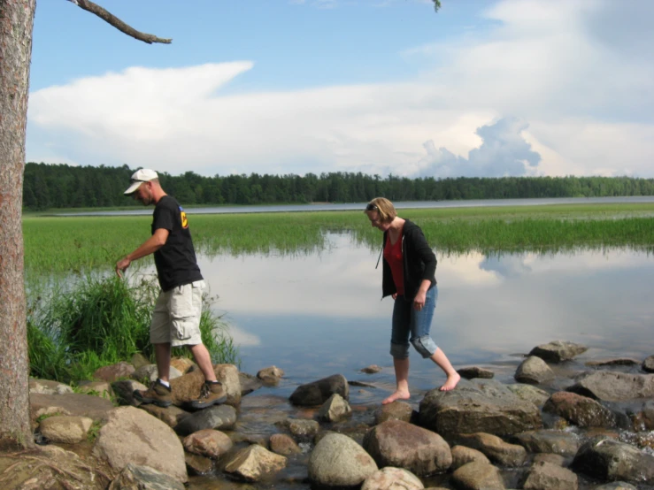 two people who are standing in some water