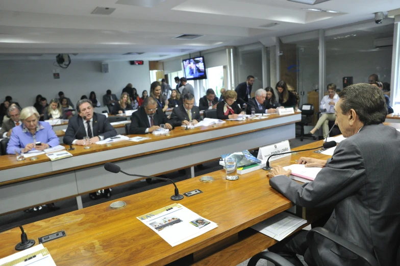 people sit at their desks in the conference room