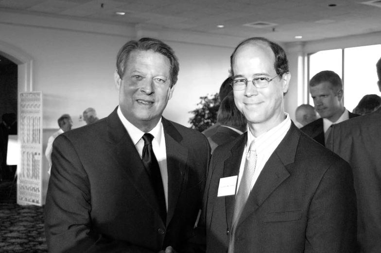 black and white pograph of two men in suits posing for camera