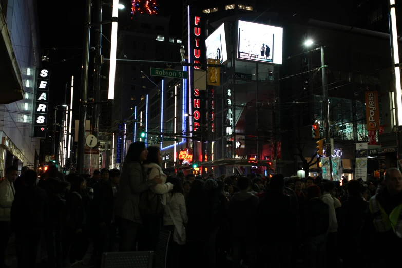 people gather in the city streets during the night