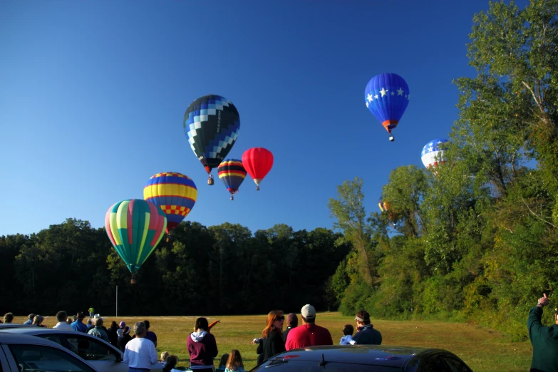 some balloons are flying in the blue sky