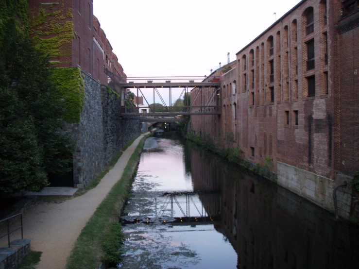 river with several brick buildings beside it