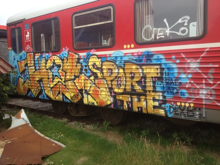 an old abandoned train with graffiti on the side