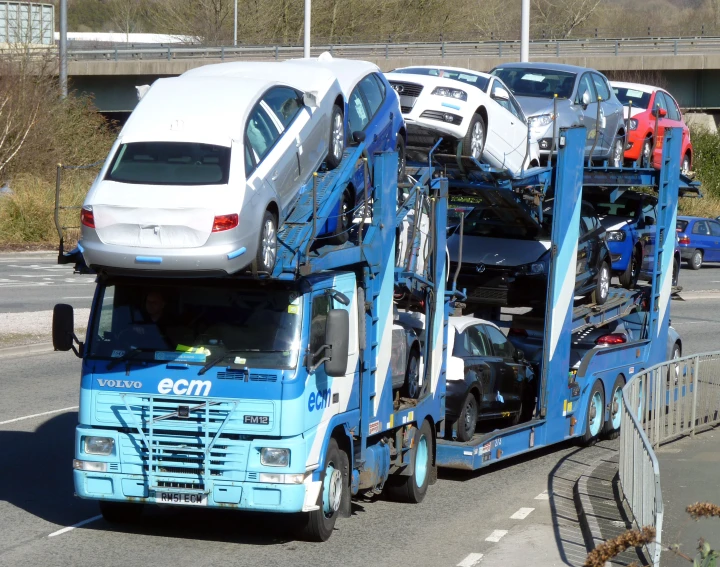 several cars are stacked on top of one another on a flatbed truck